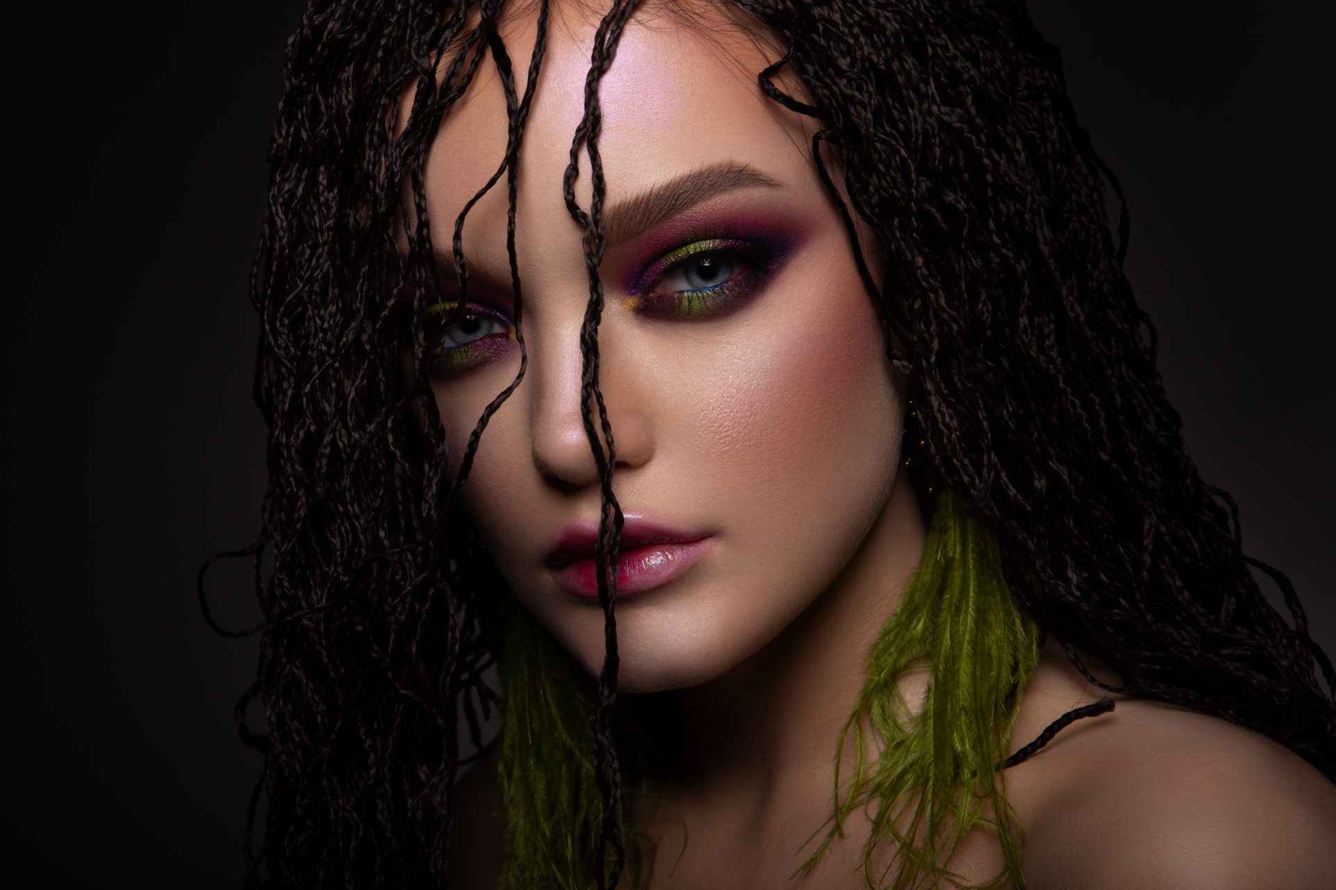 Woman with colorful make up and braids